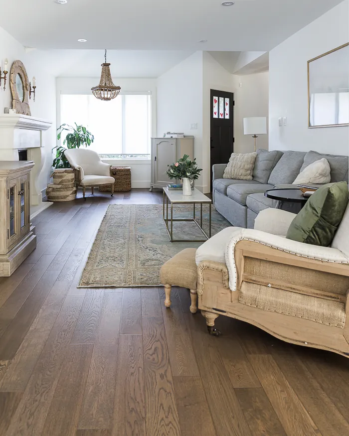 Compact sofa and round coffee table breaking up a narrow living room